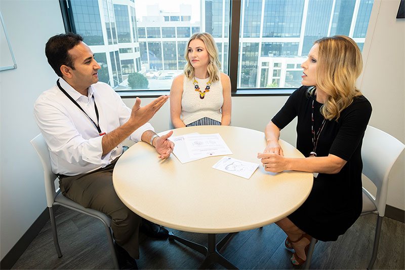 Staff from Pediatric Heart Specialists meeting with a patient.